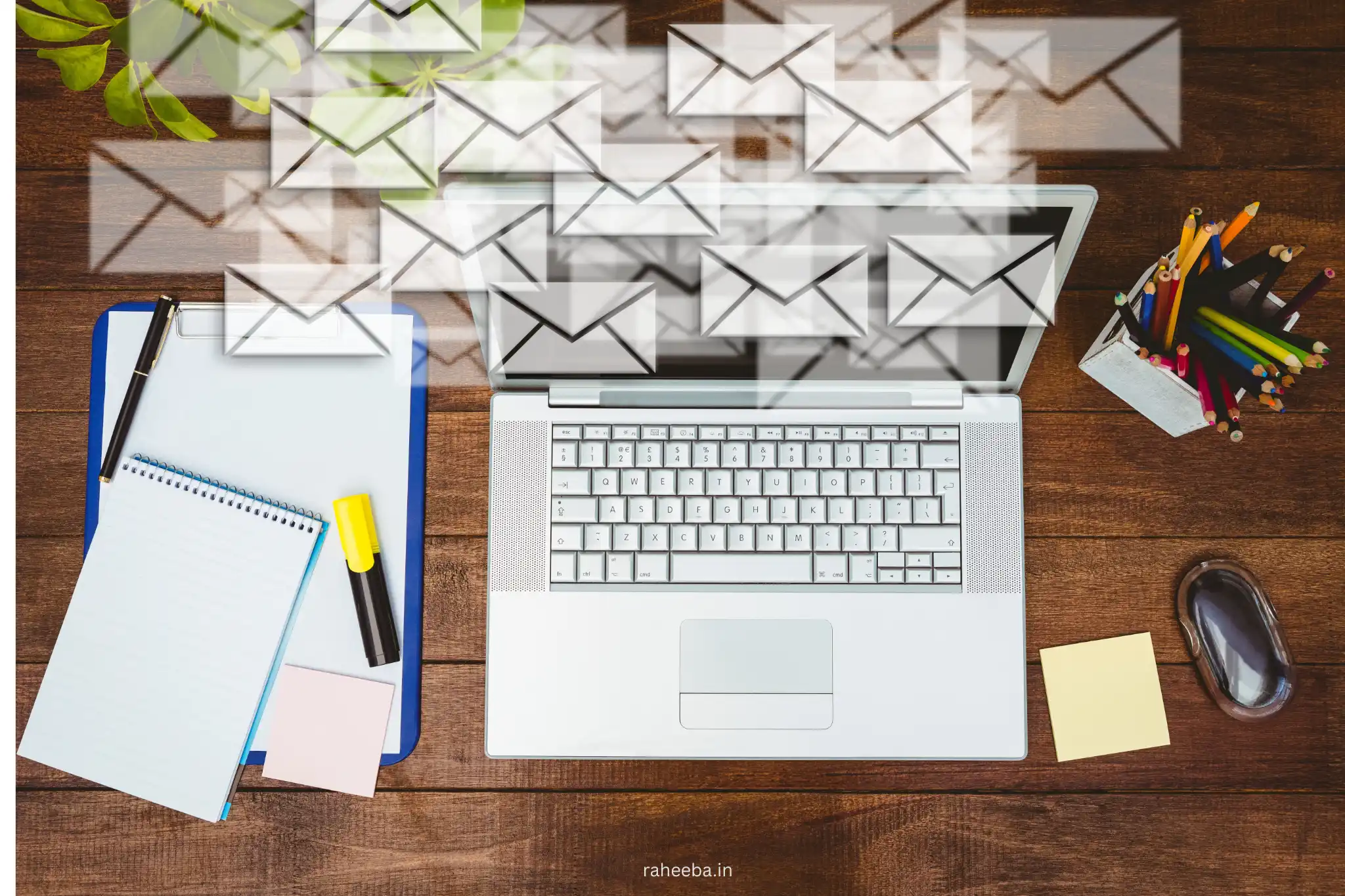 a creative digital workspace setup featuring a laptop ,notepad, phone, and planner